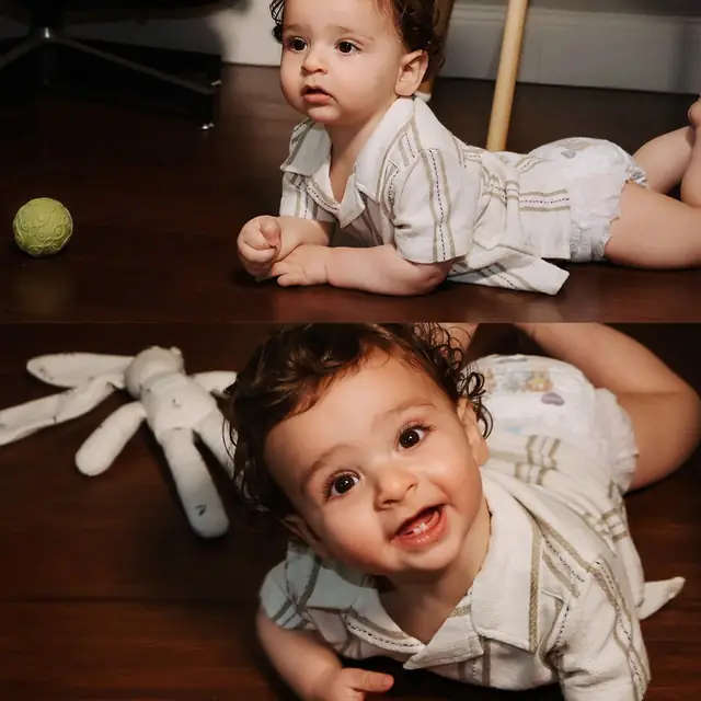 A smiling baby playing on the floor