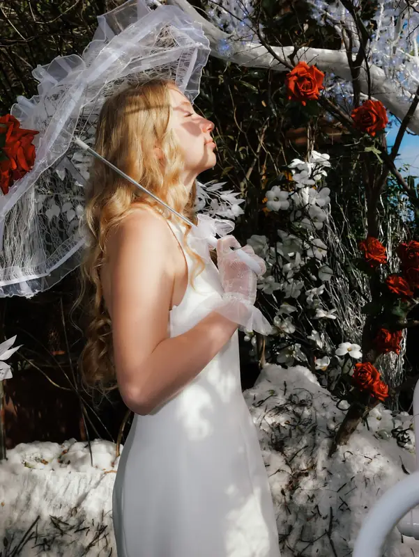 Fashion portrait among red flowers