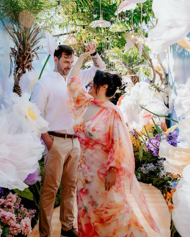 Negin and Alex surrounded by colourful flowers