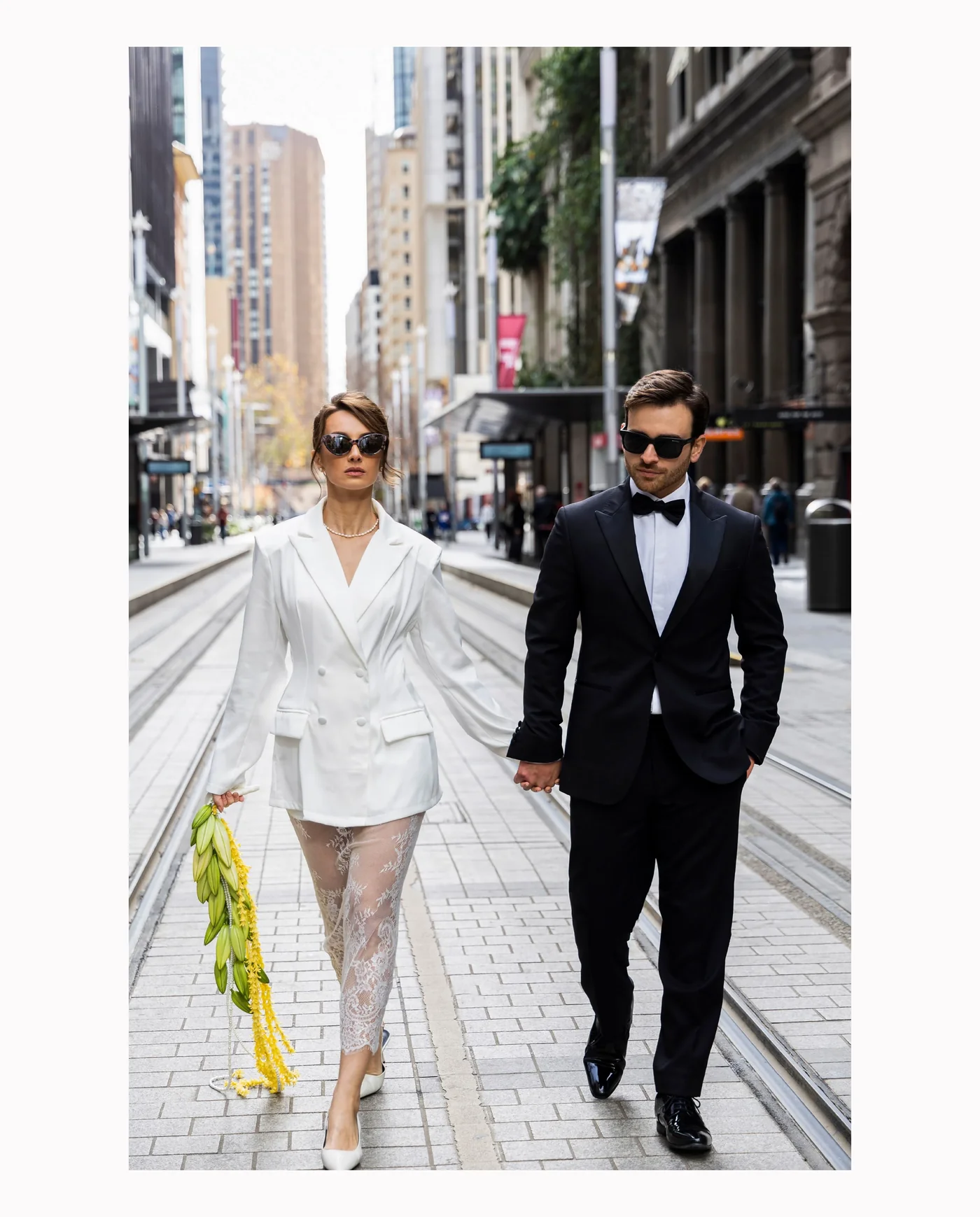 Sofi and Daniel walk together along a city street.